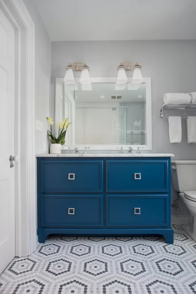 Photo of a bathroom with blue vanity. 