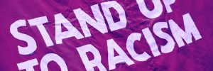 stand up to racism on a magenta flag