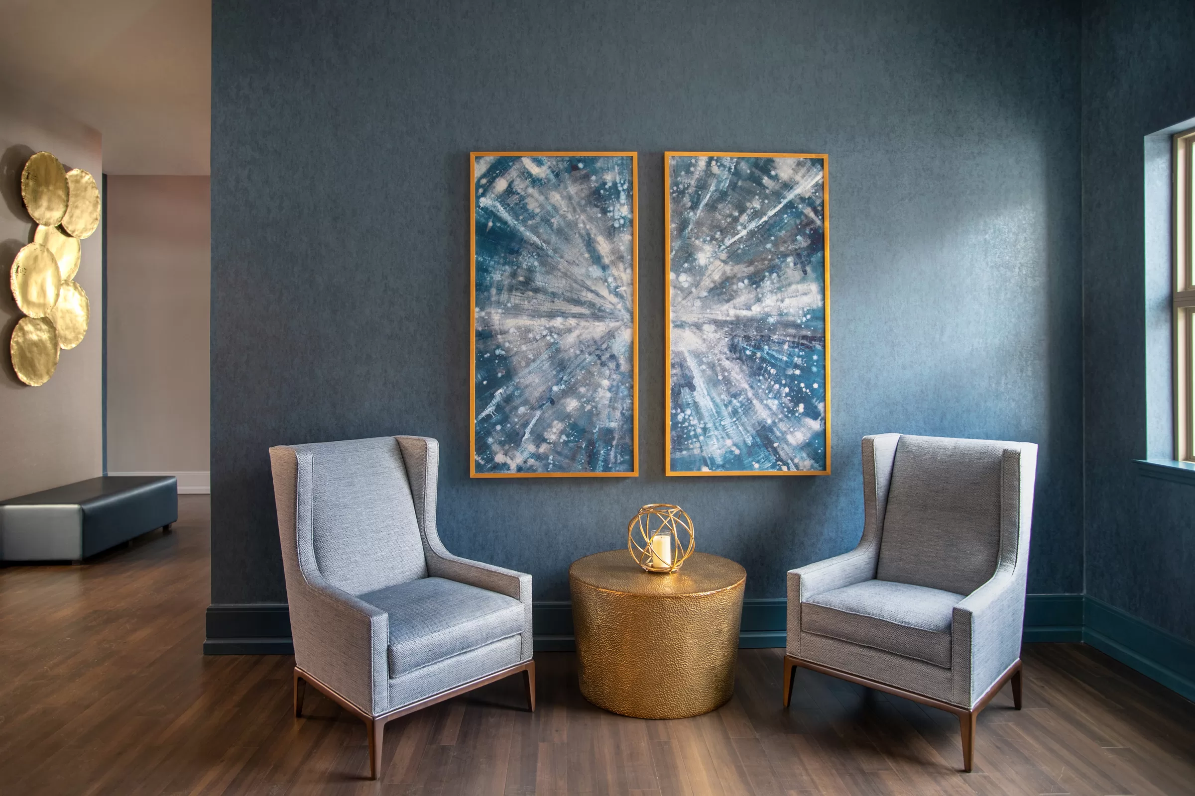 Lobby of a luxury apartment building. Featuring large artwork and statement pieces.