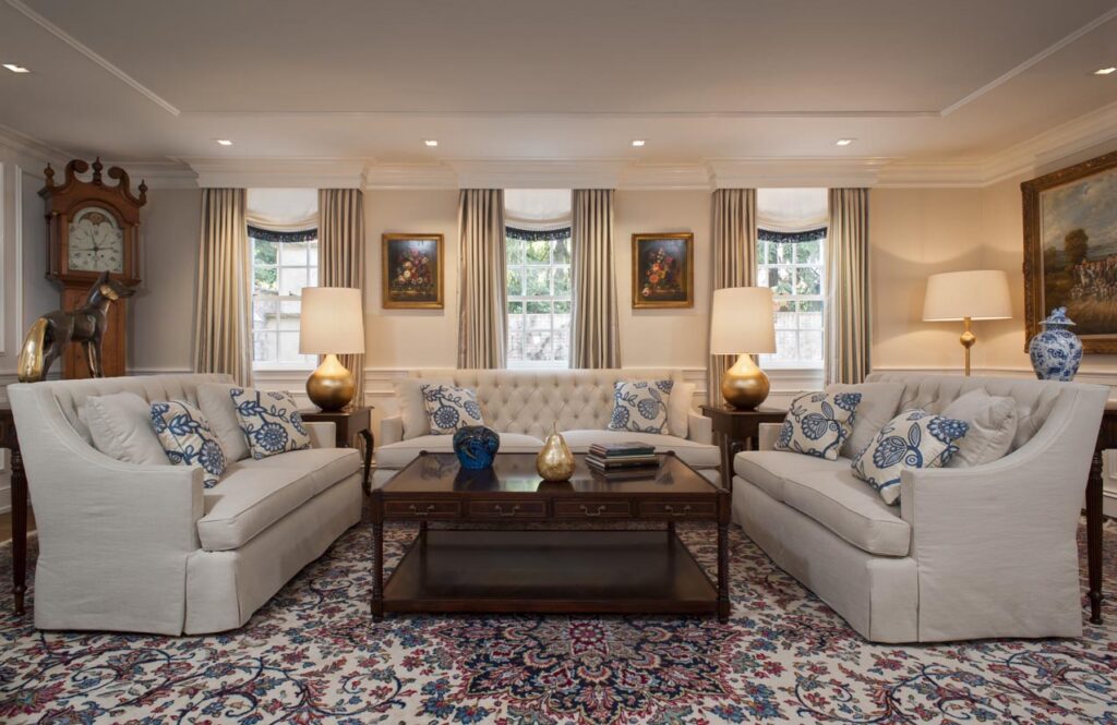 Living room with luxury drapery, neutral colors and gold accents.