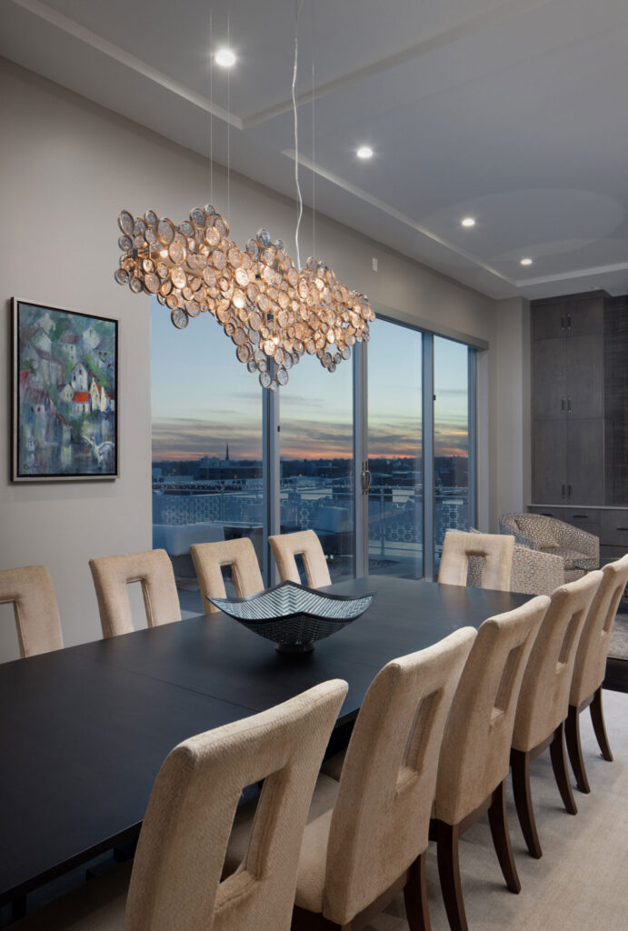 Dining area with statement lighting that views the city scape.