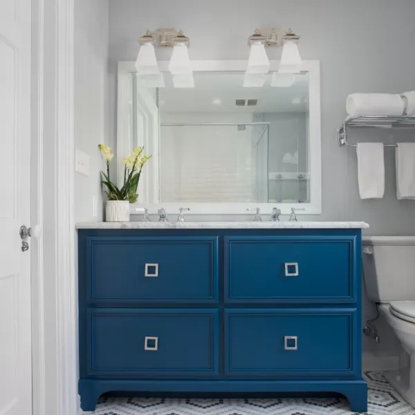 Bathroom with blue vanity and decorative tile. Photo of a bathroom with blue vanity.