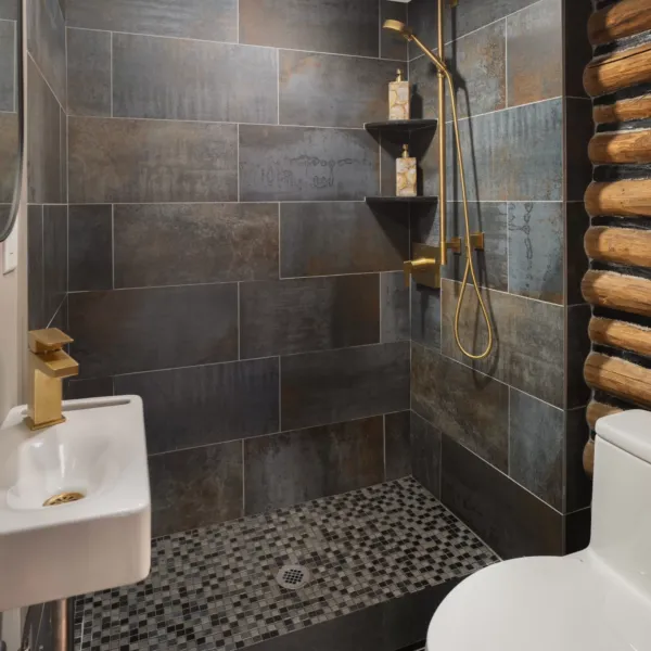 Dark shower with gold accents.