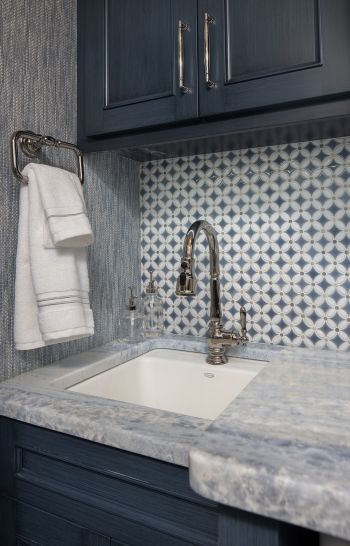 compact laundry room - close up of sink and tile; blue-grey custom cabinetry, blue and white tile backsplash, blue and white tile countertop