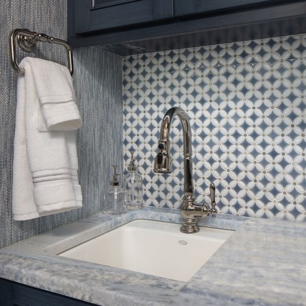 compact laundry room - close up of sink and tile; blue-grey custom cabinetry, blue and white tile backsplash, blue and white tile countertop