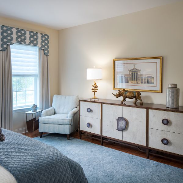 blue white and grey bedroom,, custom window treatments, quartz slab drawer hardware, white armchair, gold accents