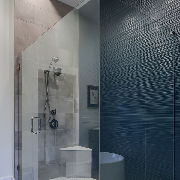modern industrial master bath - walk-in shower with teal textured wall on right and tile on right