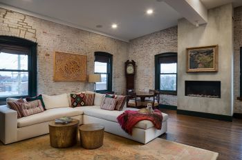 white couch, whitewashed brick wall, dark trim, dog on couch