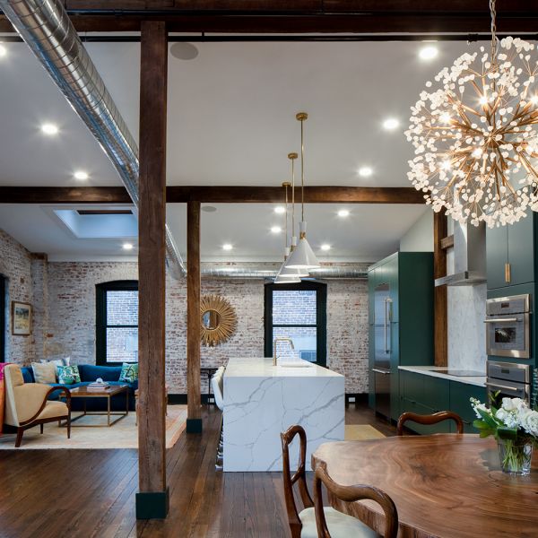 modern furniture and design in industrial warehouse penthouse, wide angle view of open floor plan living space