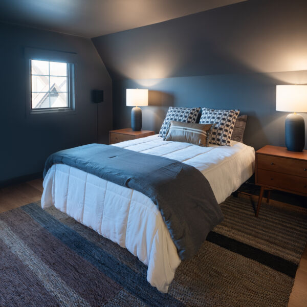 Masculine bedroom with blue walls and lights.