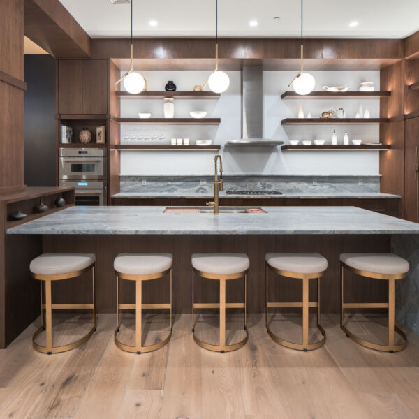 Custom walnut veneer cabinets with waterfall granite countertop
