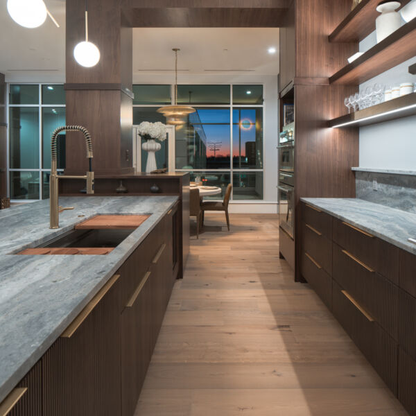 Photo of kitchen with open shelving and large island