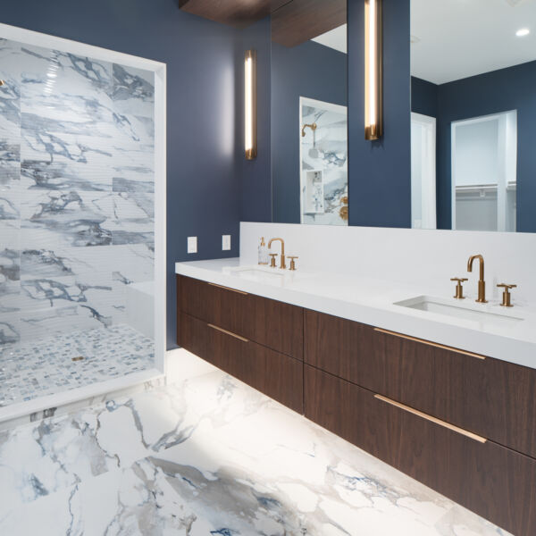 Floating walnut veneer vanity with motion sensor under lighting Bathroom vanity with walnut cabinetry